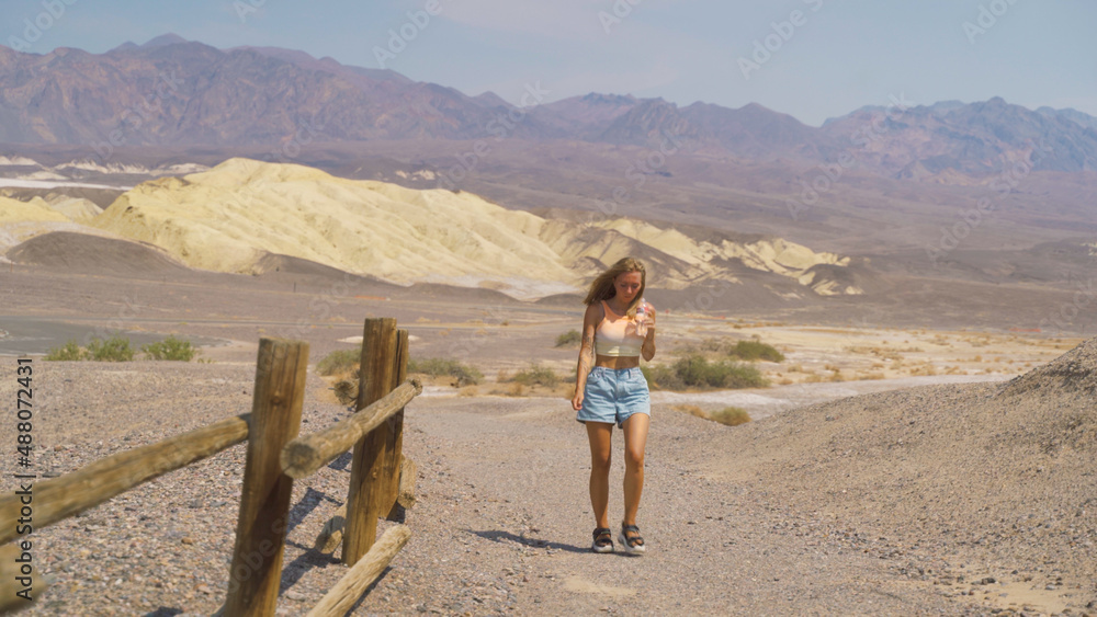 Young pretty woman exploring remains of industrial workings at the old Harmony Borax mine works in Death Valley National Park, California, USA. Young pretty woman exploring remains of industrial workings at the old Harmony Borax mine works in Death Valley National Park, California, USA.