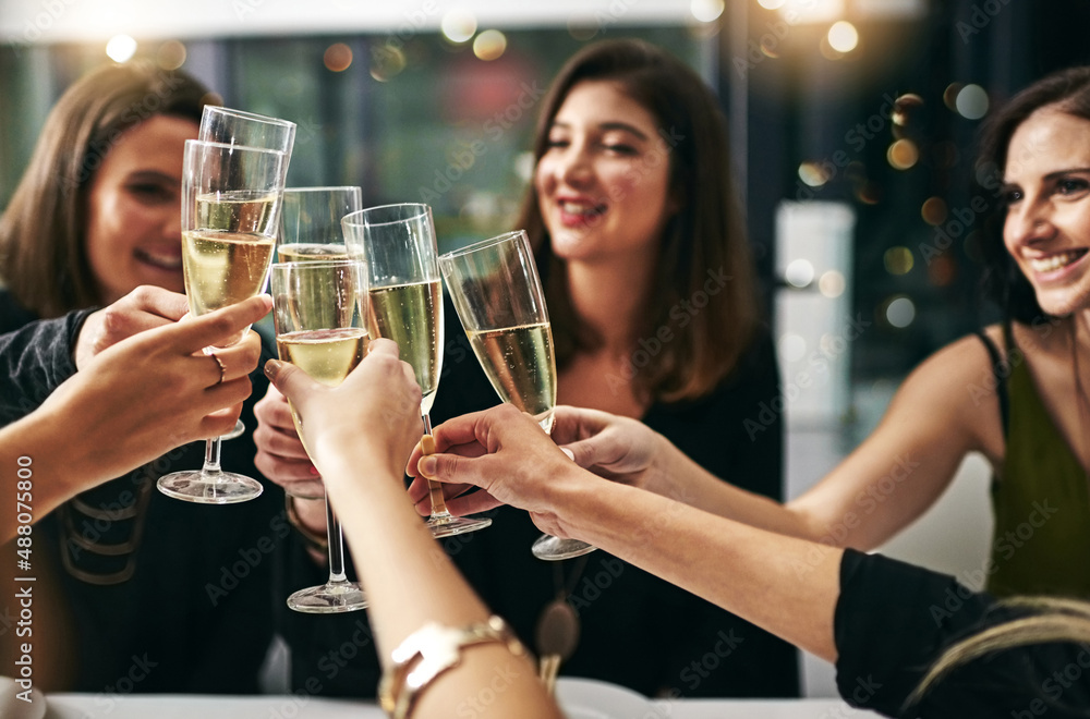 To many more nights like these. Cropped shot of a group of young girlfriends toasting during a dinner party at a restaurant.