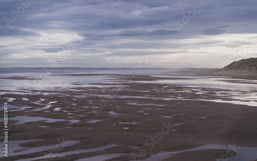 A beautiful landscape of a sandy meach on a cloudy day photo