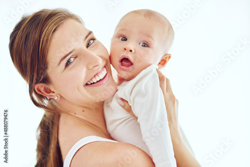 I want the best for my baby. Portrait of a loving mother carrying her baby boy at home.
