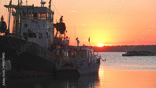 Old abandoned fishing boat at sunset