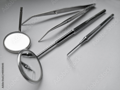 Dental instruments for exam. Stainless equipment. Mirror, tweezers, probe, closeup