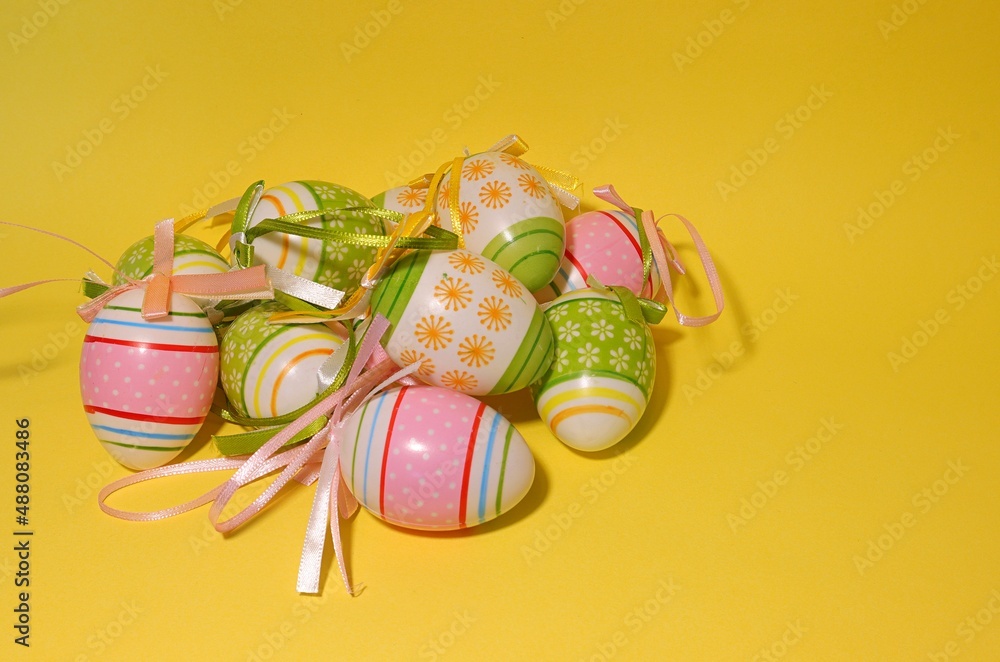 Easter, on the front colorful painted easter eggs all on orange or yellow background. Easter, on the front colorful painted easter eggs all on orange or yellow background.