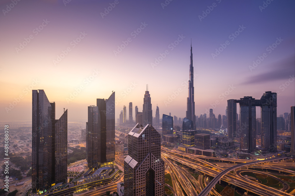 Modern city skyline and cityscape at sunrise in Dubai UAE