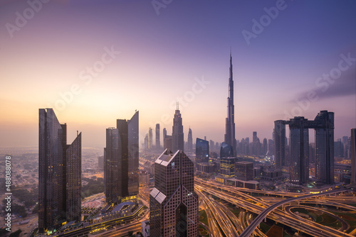 Modern city skyline and cityscape at sunrise in Dubai UAE