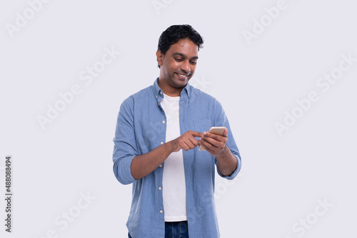 Indian Man Standing Using Phone Isolated. Man Texting on Phone. Technology