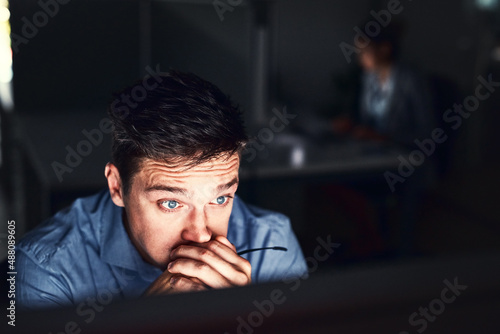 Oh no this cant be happening at this time. Cropped shot of a young attractive businessman working late in the office. © Jadon Bester/peopleimages.com