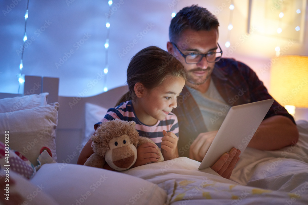 I learn new things from her everyday. Shot of a little girl and her father using a tablet before bedtime. I learn new things from her everyday. Shot of a little girl and her father using a tablet before bedtime.