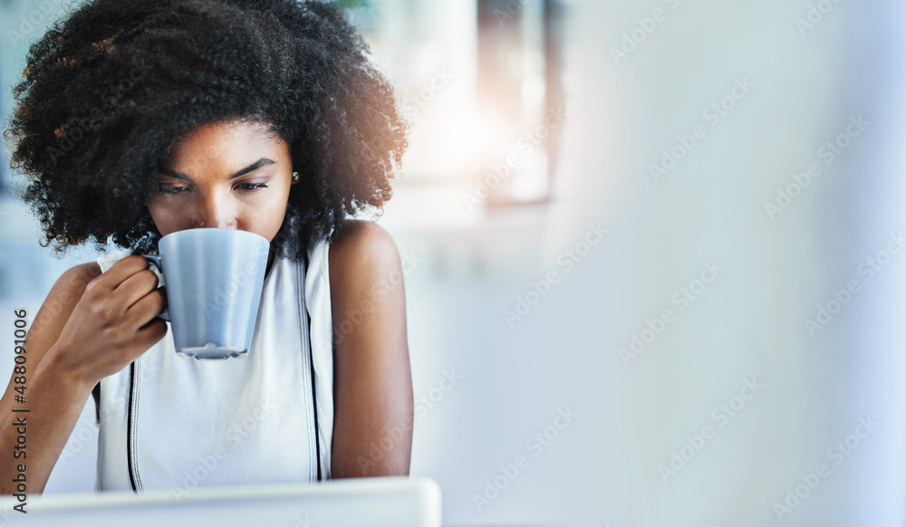 Coffee gets her going. Cropped shot of an attractive young businesswoman drinking a cup of coffee in her office. Coffee gets her going. Cropped shot of an attractive young businesswoman drinking a cup of coffee in her office.