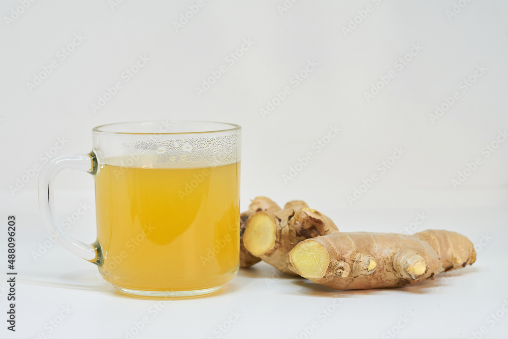 Glass of ginger tea lemon with ginger on white background. Glass of ginger tea lemon with ginger on white background.