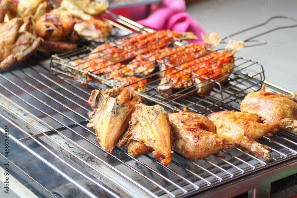 grilled chicken and fish on a grill