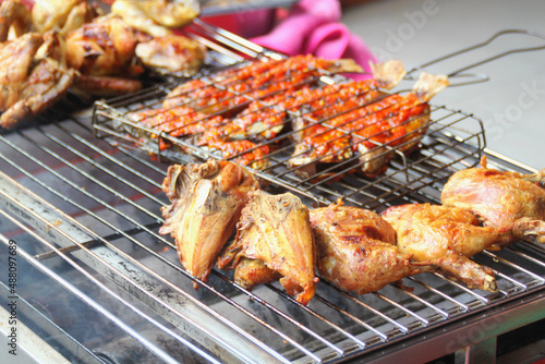 grilled chicken and fish on a grill