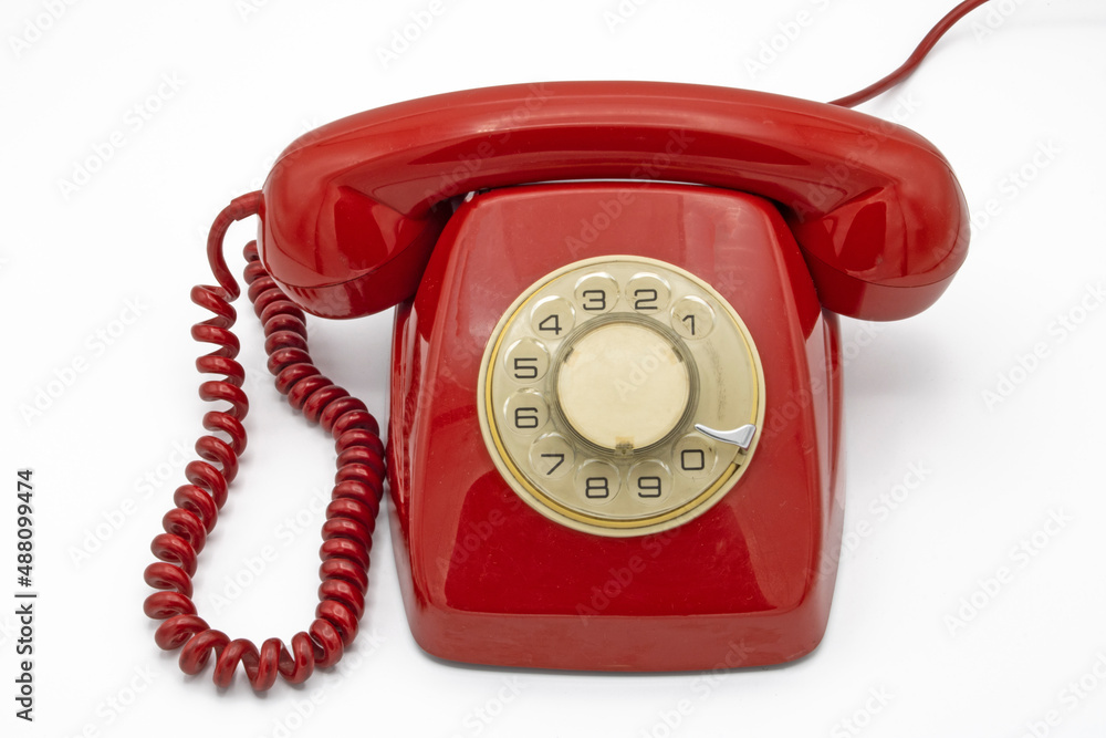 Old red telephone, isolated on a white background Old red telephone, isolated on a white background
