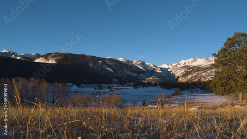 Sun rising over a Snowy Moraine Park with Distant Mountains in Colorado Hyperlapse