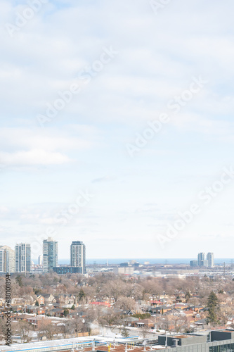 views of downtown Toronto from mimco with snow and trees blue skies lake view and CN tower in view 