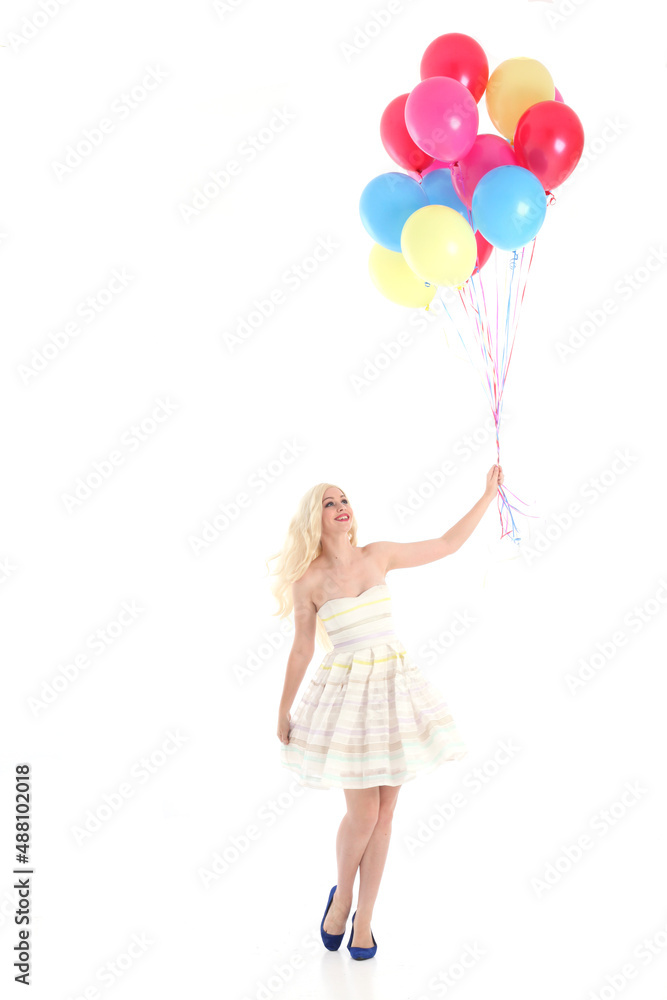 Full length portrait of blonde girl wearing party dress, holding bunch of colourful balloons. Isolated on white studio background
Full length portrait of blonde girl wearing party dress, holding bunch of colourful balloons. Isolated on white studio background