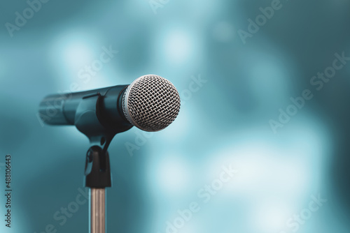 Microphone with stage light background for performance concept of speech comment and public speaking