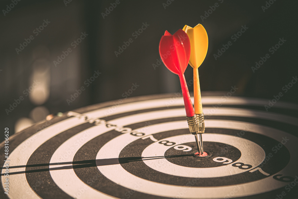 Bullseye target goal or dartboard has dart arrow throw hitting center shooting for financial business targeting planning to winner concept. Bullseye target goal or dartboard has dart arrow throw hitting center shooting for financial business targeting planning to winner concept.