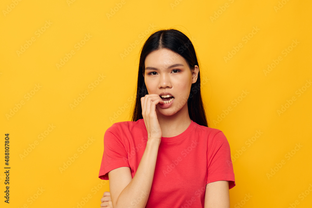 woman with Asian appearance red t-shirts posing modern style isolated background unaltered