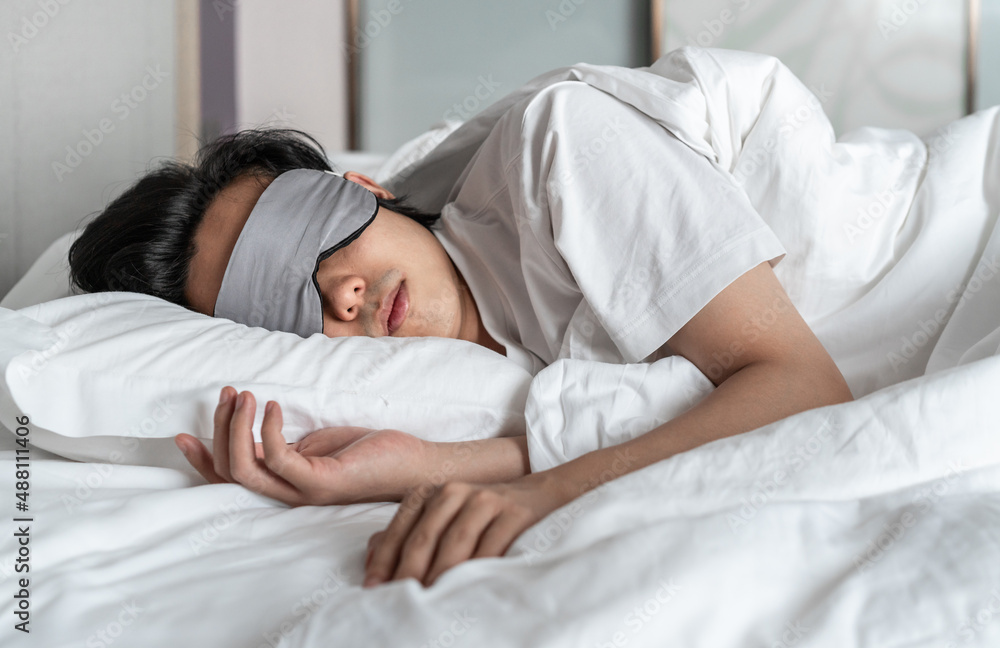man wearing eye mask is sleeping on the bed Stock Photo Adobe Stock