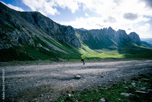 Woman trail runner running on mountain top