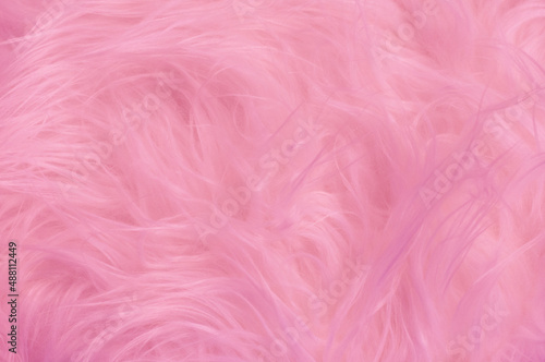 Texture of pink fur, long fibers of faux fur, wool and hair. Fur blanket, warm cape for the interior, home comfort, noisy structure
