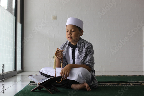 Religious Muslim children dhikr in the mosque photo