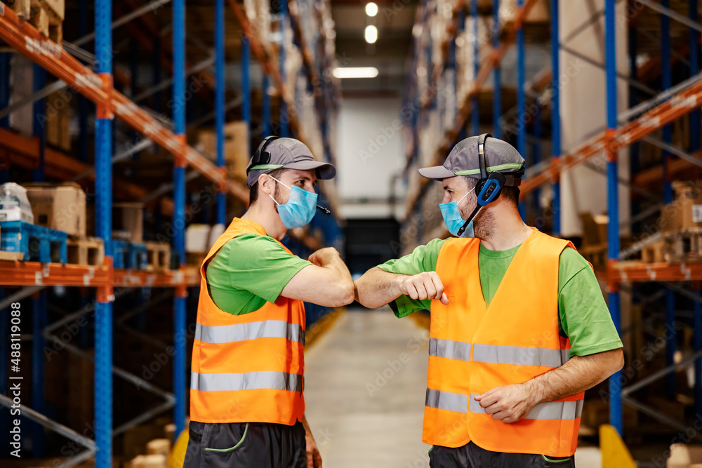 Post office workers with voice picking headsets giving corona greeting at each other. Post office workers with voice picking headsets giving corona greeting at each other.
