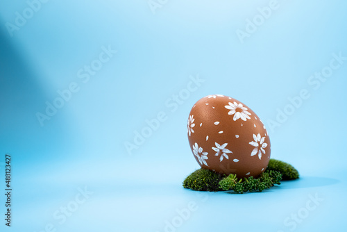 painted egg on a blue background, easter egg, space for text