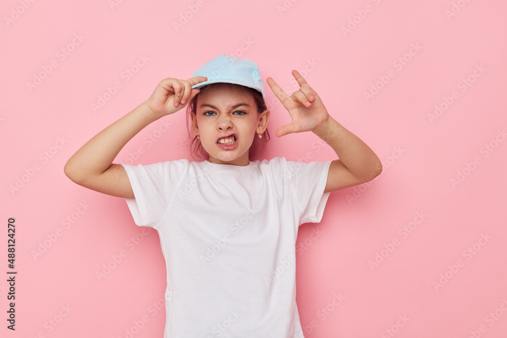 Portrait of happy smiling child girl posing white tshirt emotion pink background Portrait of happy smiling child girl posing white tshirt emotion pink background