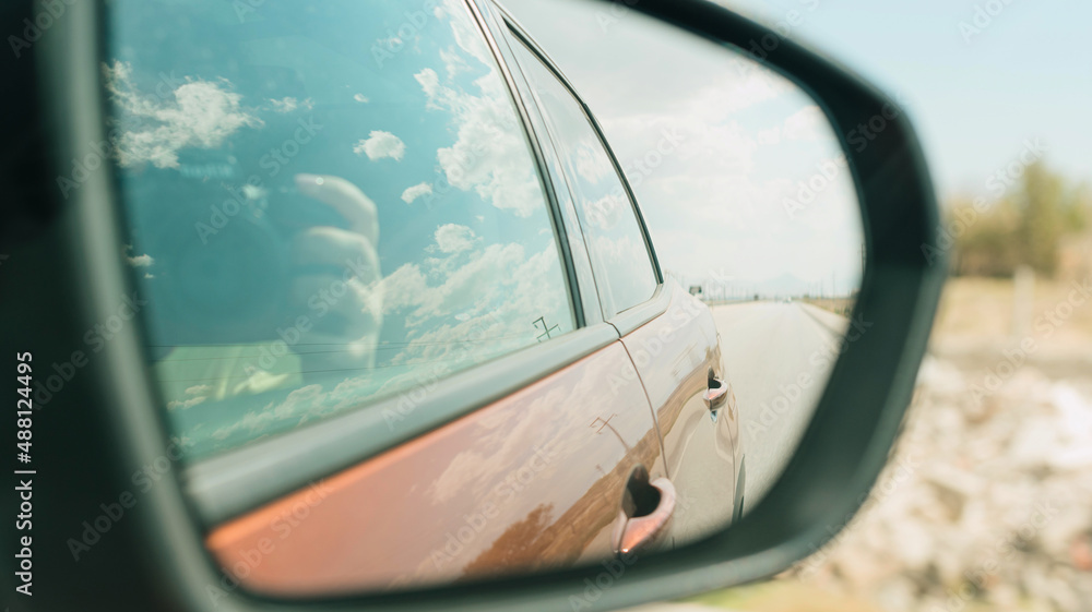 Passenger riding in car and taking photo from window on a road trip Passenger riding in car and taking photo from window on a road trip
