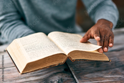 I just have to go back to the previous page. Cropped shot of an unrecognizable man reading a book.