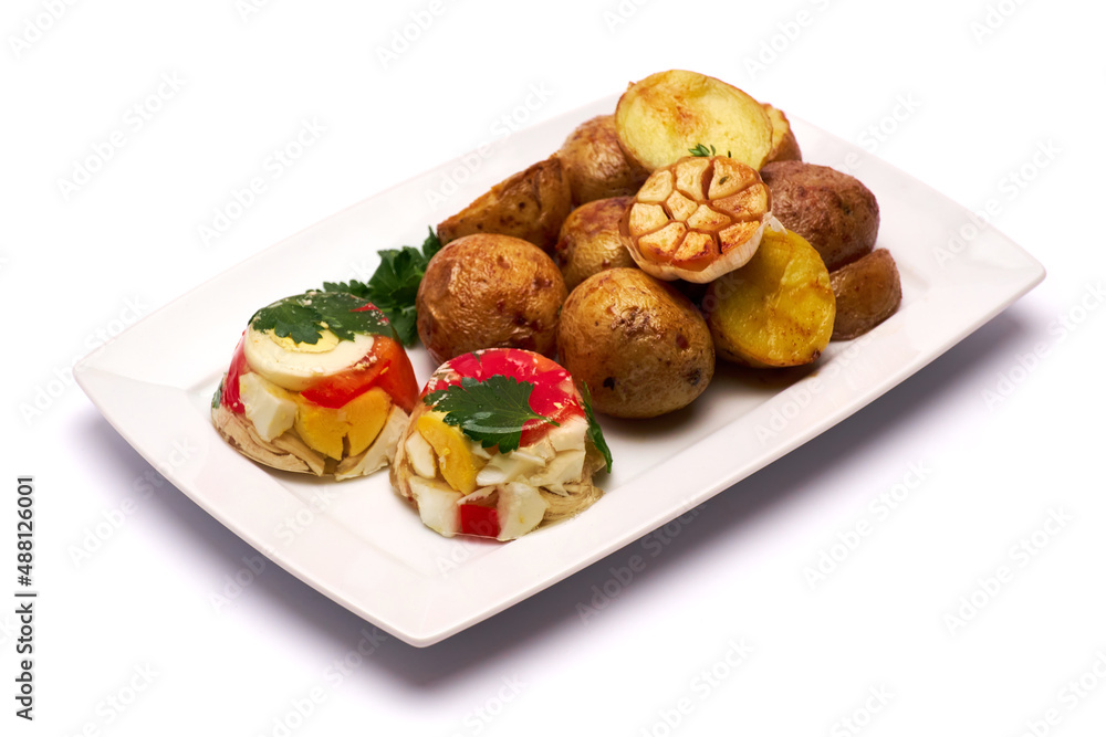 Portion of delicious chicken aspic and baked potato on a plate isolated on white background Portion of delicious chicken aspic and baked potato on a plate isolated on white background