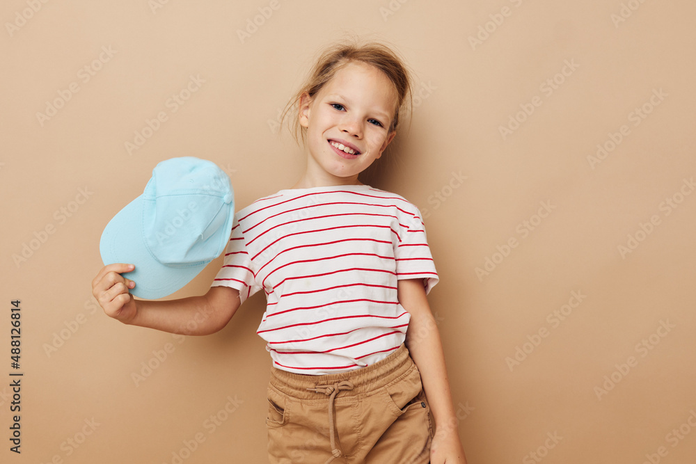 cute girl in blue caps striped t-shirt emotions isolated background cute girl in blue caps striped t-shirt emotions isolated background