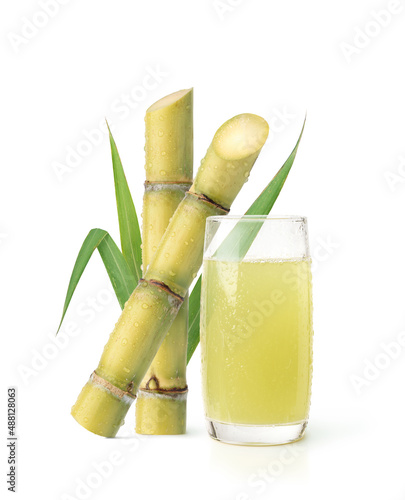 Cool squeezed sugar cane juice with fresh sugar cane isolated on white background.
