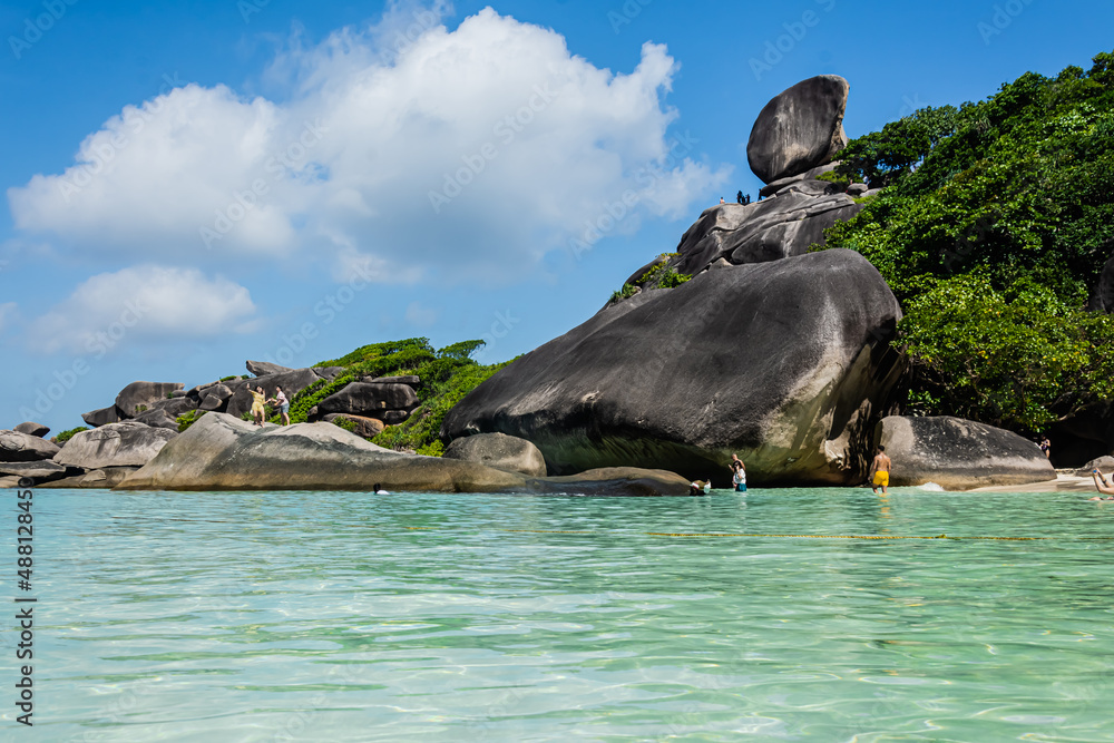 Fototapeta premium Beautiful landscape people on rock is a symbol of Similan Islands, blue sky and cloud over the sea during summer at Mu Ko Similan National Park, Phang Nga province, Thailand