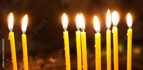Fotografie, Obraz red candles burning in the dark - black background