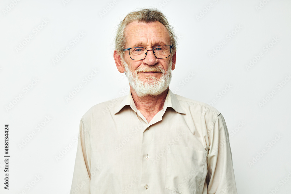 Portrait elderly man with a gray beard in a shirt and glasses light background Portrait elderly man with a gray beard in a shirt and glasses light background