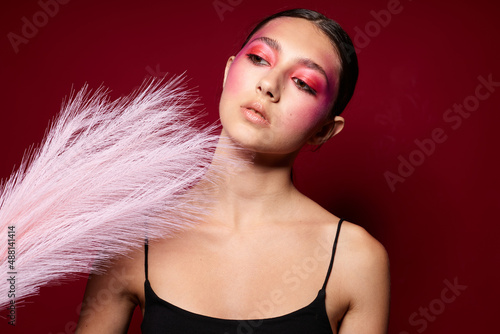 attractive woman with bright makeup feather charm