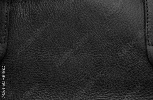 Closeup of seamless black leather texture background, surface material for fashion dark pattern luxury decoration.