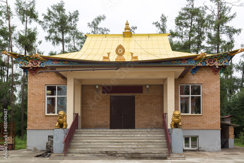 A large Buddhist temple datsan with a golden roof.