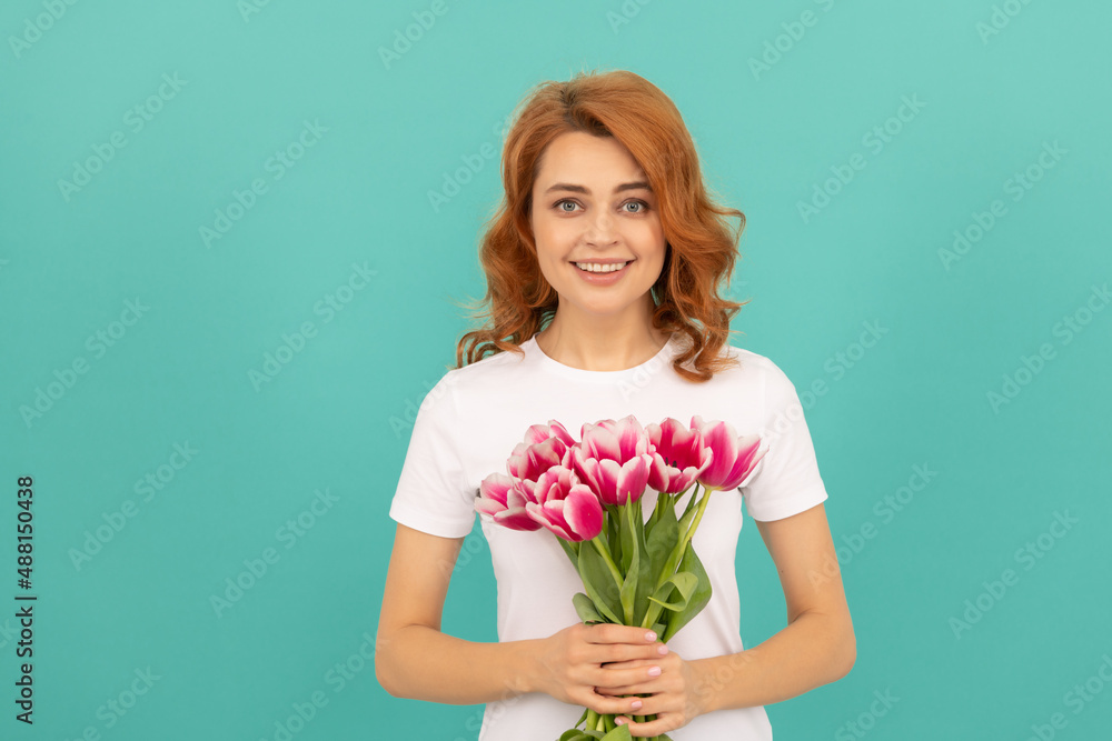 cheerful woman with tulip flower bouquet on blue background cheerful woman with tulip flower bouquet on blue background