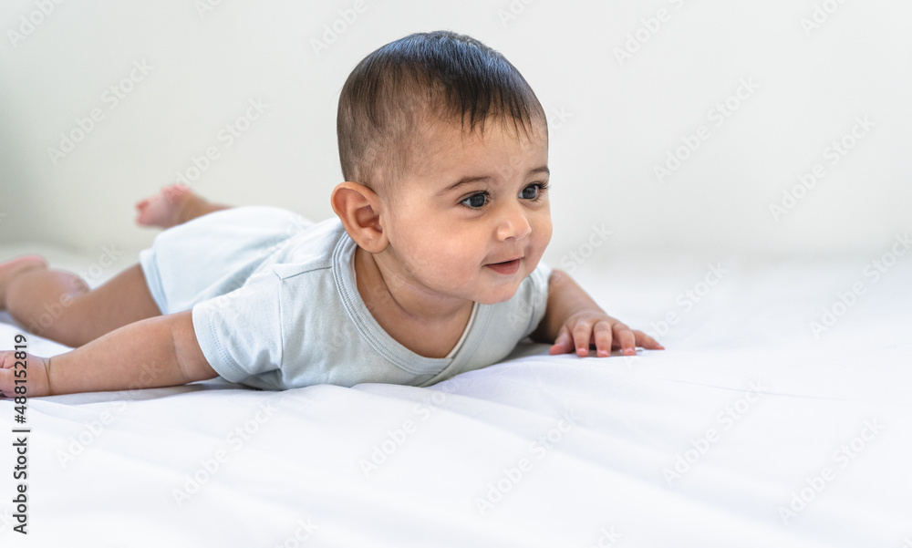 Portrait of happy little baby lying on bed Portrait of happy little baby lying on bed