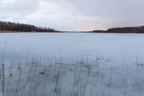 Ice covered lake Lielezers in winter on a clody day in Latvia