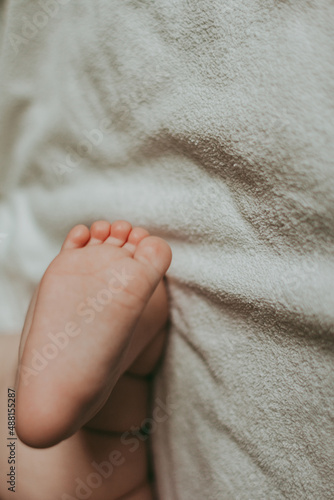 Feet of a newborn on a white blanket