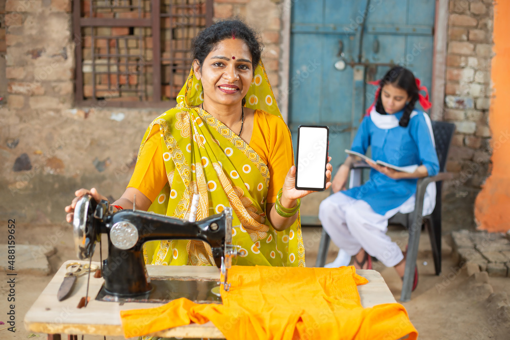 Portrait Of Happy Traditional Indian Woman Wearing Sari Using Sewing Portrait of happy traditional indian woman wearing sari using sewing