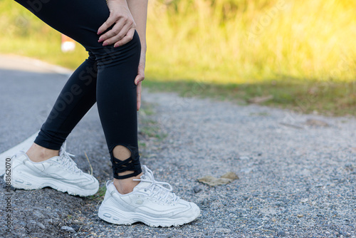 Female runners have leg cramps from accidents, sports injuries, knee pain, and problems after running and exercising outdoors in the summer.