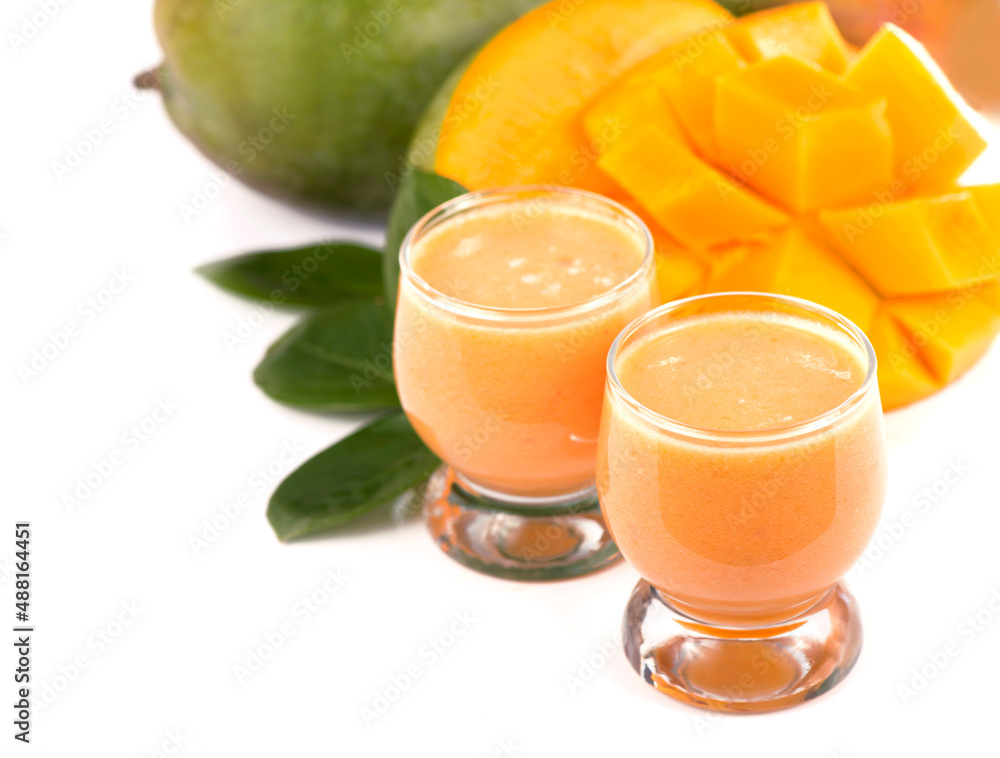 juicy, fresh exotic fruit mango and glasses of juice on a white background juicy, fresh exotic fruit mango and glasses of juice on a white background
