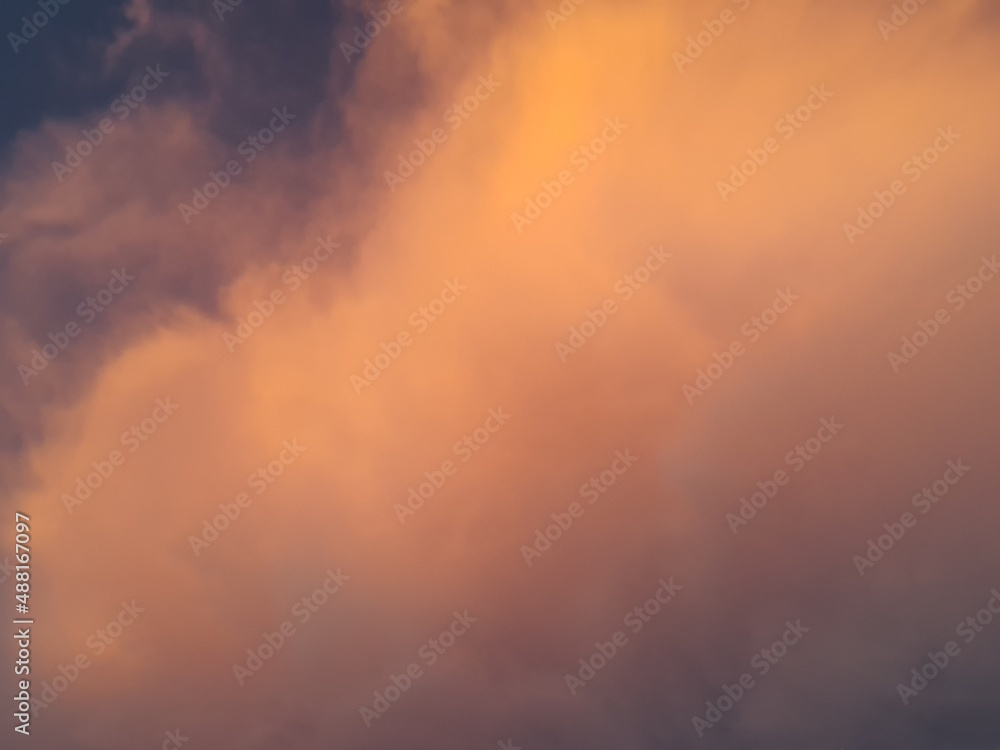 Beautiful cloudy sky, in shades of orange between the clouds.