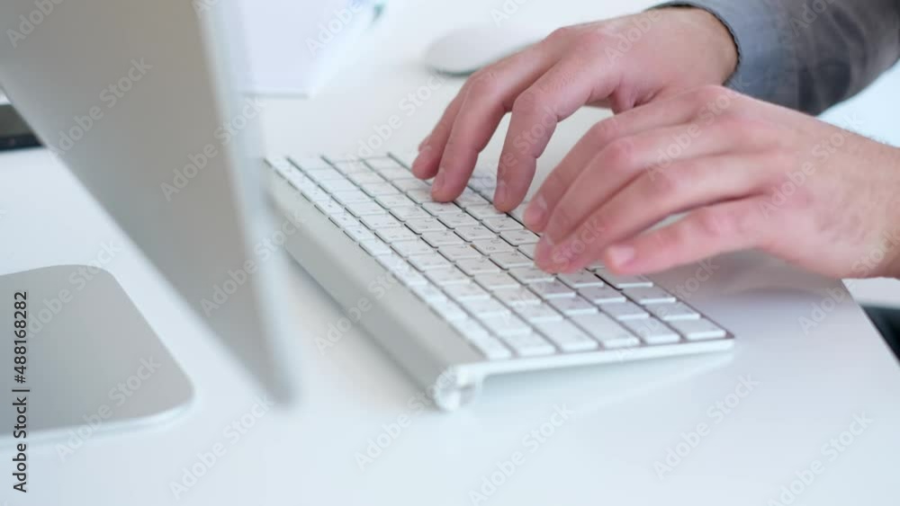 Man texting a message on keyboard close up Man texting a message on keyboard close up